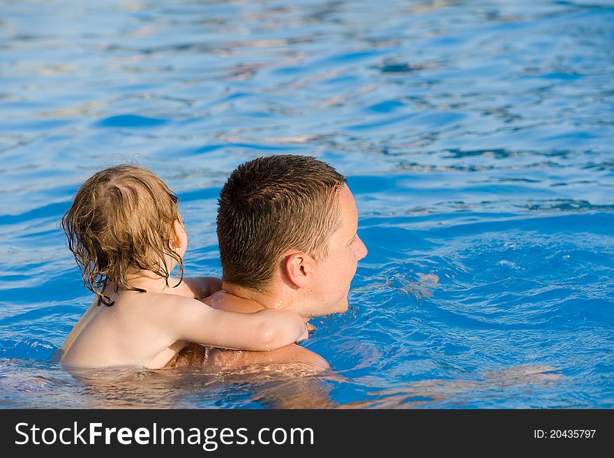 Baby On The Father S Neck Is Swimming In Pool