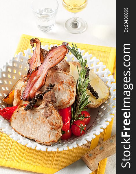Roasted pork chops with  potato and red peppers