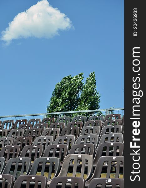 Tennis court empty places in a sunny day with fluufy clouds in the sky