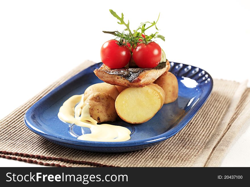 Pan fried trout served with new potatoes. Pan fried trout served with new potatoes