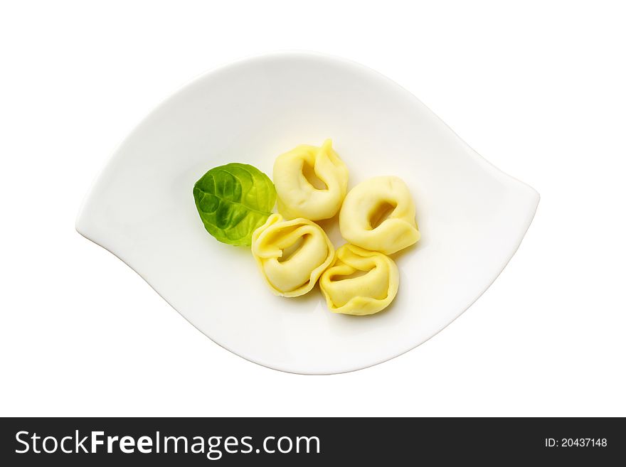 Stuffed pasta on a modern plate - overhead, cut out on white