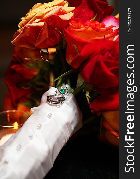 Bride and Grooms wedding rings on white ribbon of flower bouquet. Bride and Grooms wedding rings on white ribbon of flower bouquet.