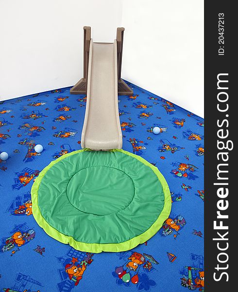 Playground for children with colored carpet with children slide. Playground for children with colored carpet with children slide