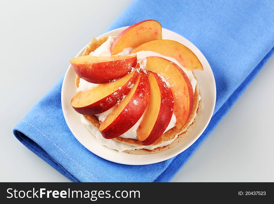Pancakes with sweet cheese and wedges of fresh nectarine. Pancakes with sweet cheese and wedges of fresh nectarine