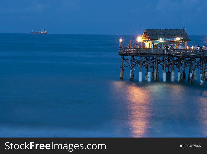 Pier at night with calm water and reflection. Pier at night with calm water and reflection