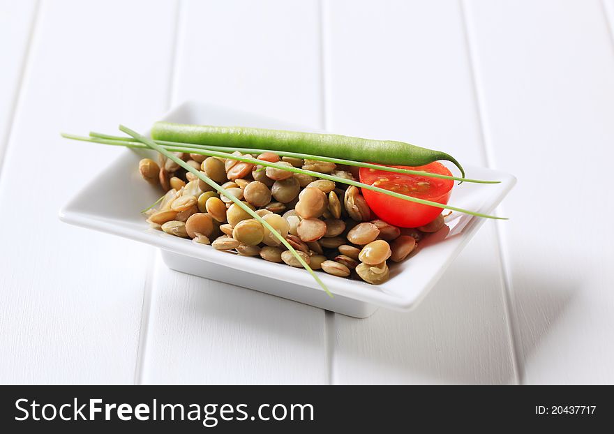 Vegetarian accompaniment - Cooked lentils on a rectangular plate