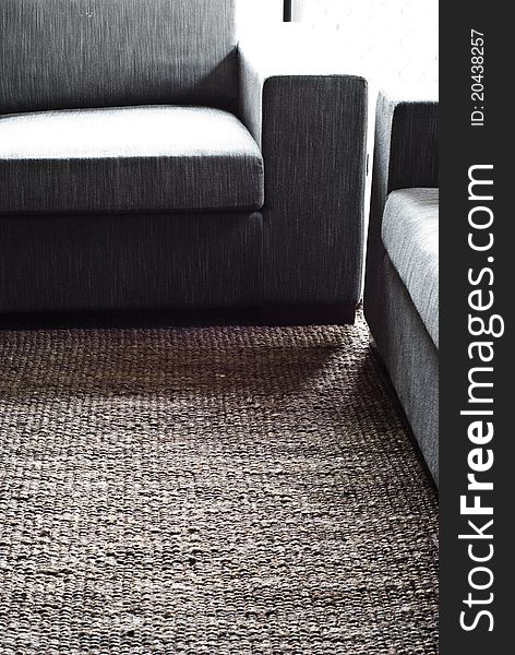 Brown hemp rug and fabric couch setting