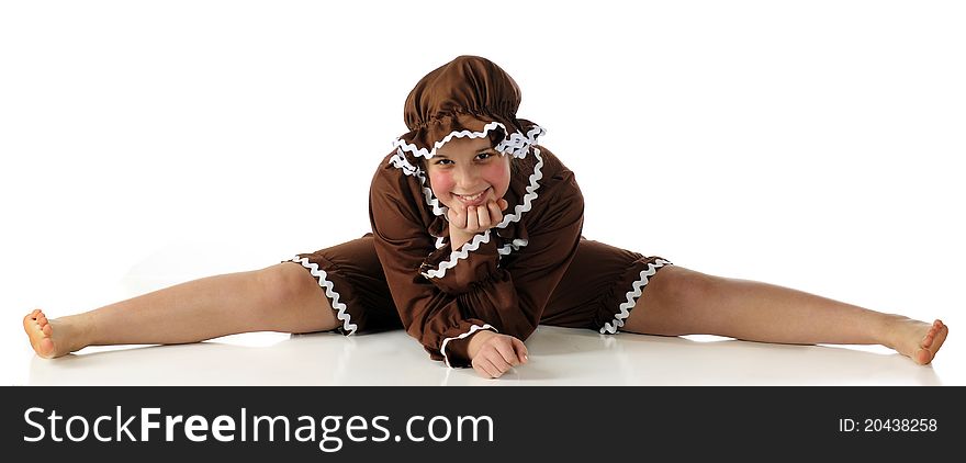 A happy girl in a gingerbread outfit doing the splits. Isolated on white. A happy girl in a gingerbread outfit doing the splits. Isolated on white.