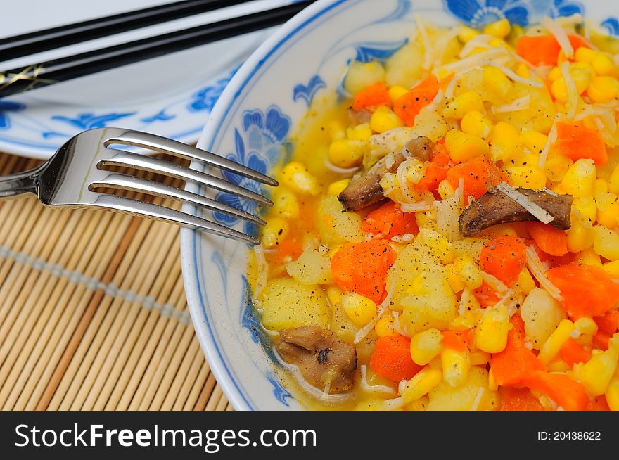 Simple potato cuisine with mixed ingredients in large Oriental bowl. Simple potato cuisine with mixed ingredients in large Oriental bowl.