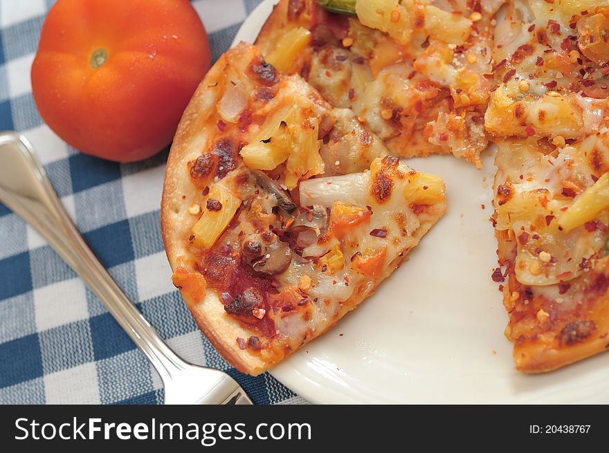 Sliced sumptuous vegetarian cheese pizza on white plate ready to be eaten. Topped with hot spices and herbs. Sliced sumptuous vegetarian cheese pizza on white plate ready to be eaten. Topped with hot spices and herbs.