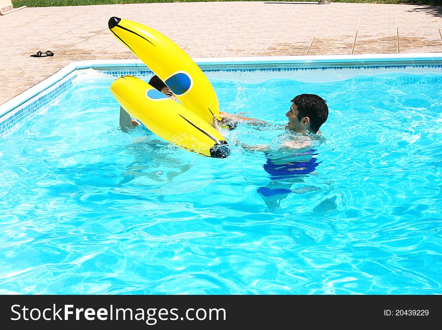 Couple having fun in swimming pool. Couple having fun in swimming pool.