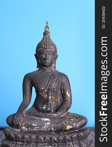 Buddha statue on blue background