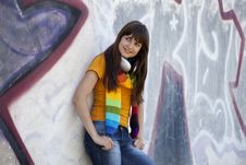 Teen Girl With Earphones Near Graffiti Wall. Royalty Free Stock Photography Teen Girl With Earphones Near Graffiti Wall. Royalty Free Stock Photography