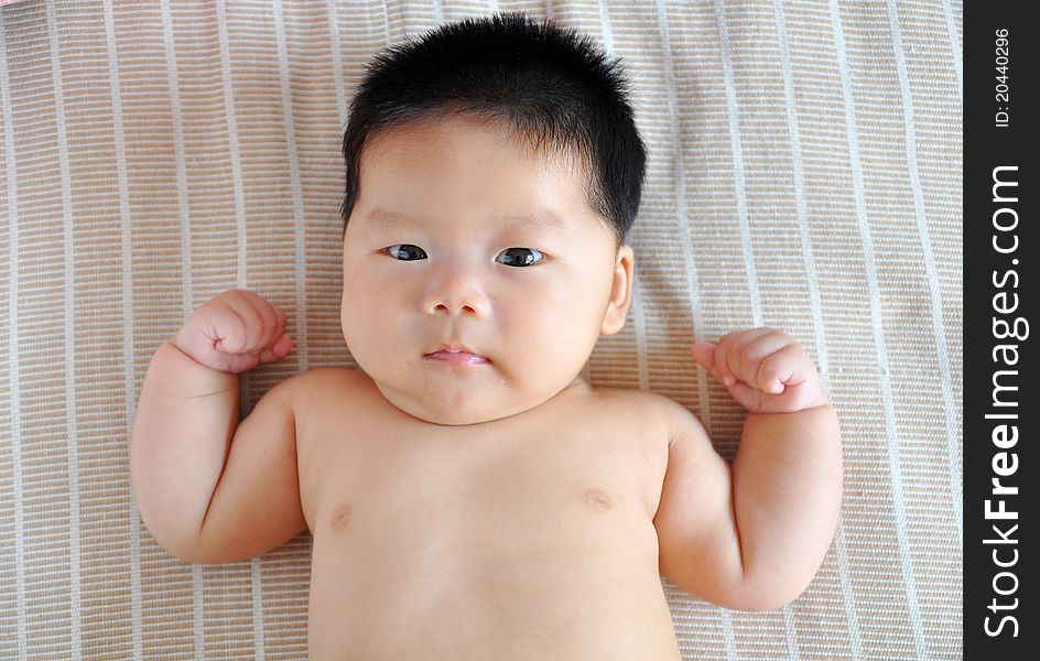 A 2 months chinese Baby girl lying on the bed