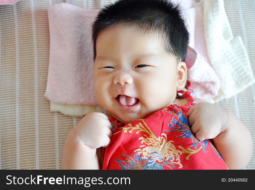 A 2 months chinese Baby girl lying on the bed. A 2 months chinese Baby girl lying on the bed