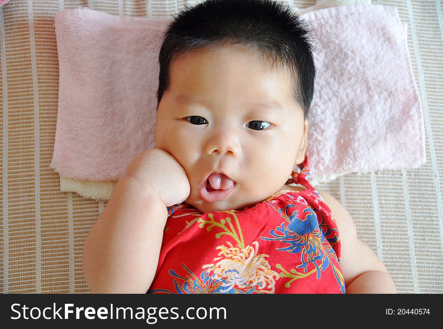 A 2 months chinese Baby girl lying on the bed