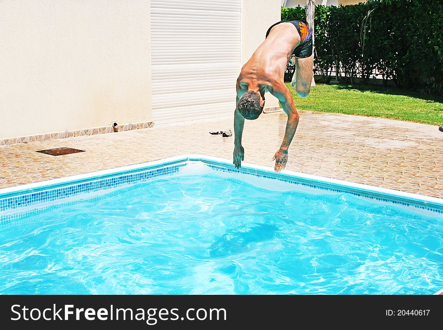 Man jumping to swimming pool.