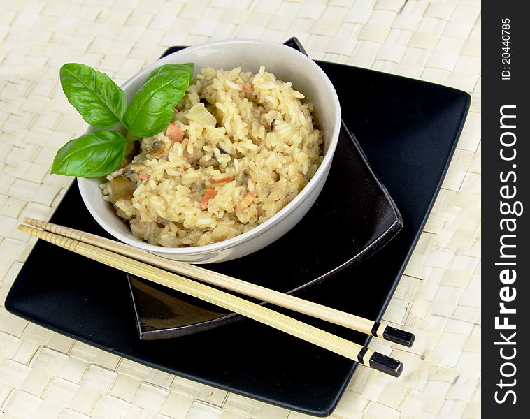 Vegetarian Risotto with Asian look and feel. Chopsticks and basil details. Vegetarian Risotto with Asian look and feel. Chopsticks and basil details.