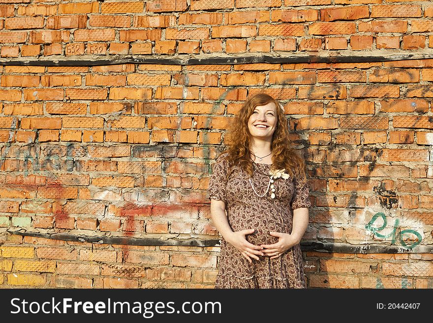 Full length of 9 months pregnant woman stands on street