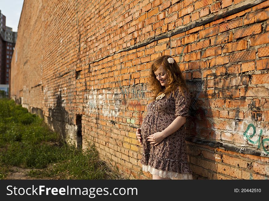 Full length of 9 months pregnant woman stands on street