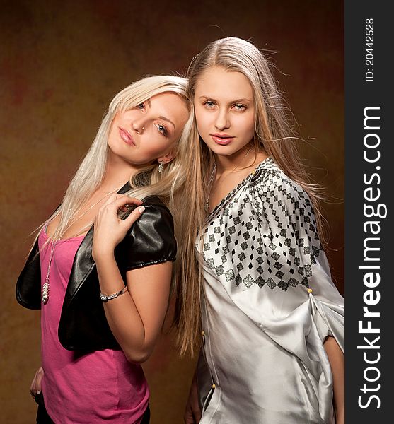 Two beautiful women on a colored background