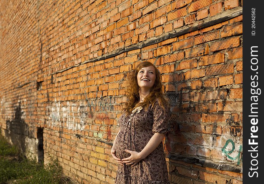 Full length of 9 months pregnant woman stands on street