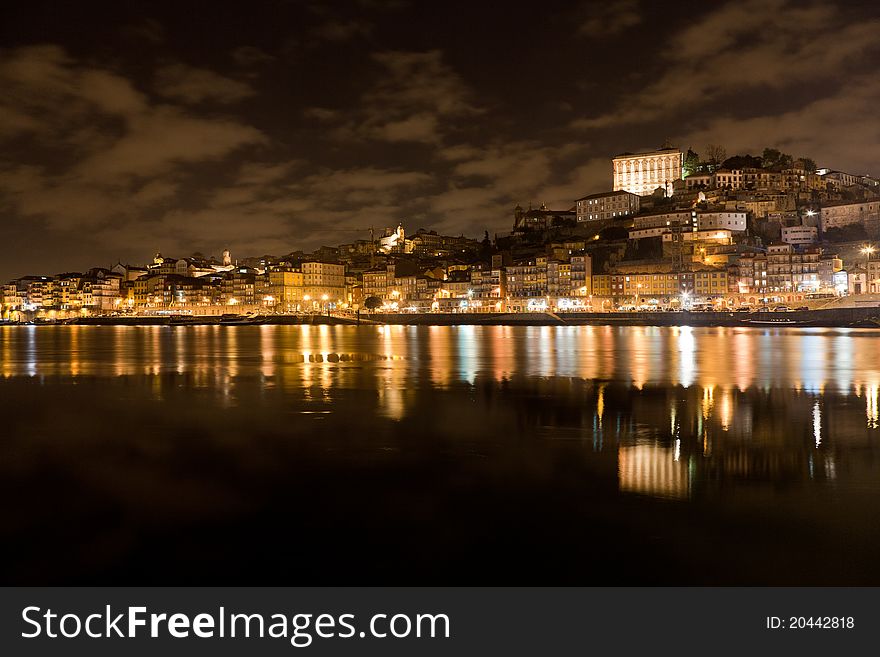 City landscape of Oporto, Portugal at night. Shot taken from the Gaia margin into Oporto's riverbank side. You can see the Oporto's Cathedral on top of the hill. City landscape of Oporto, Portugal at night. Shot taken from the Gaia margin into Oporto's riverbank side. You can see the Oporto's Cathedral on top of the hill.