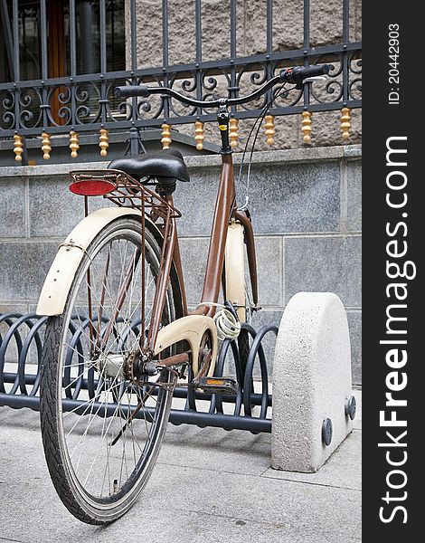 Brown old bike in city landscape