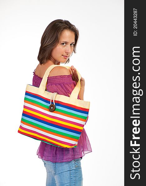 Beautiful woman holding beach bag on white background