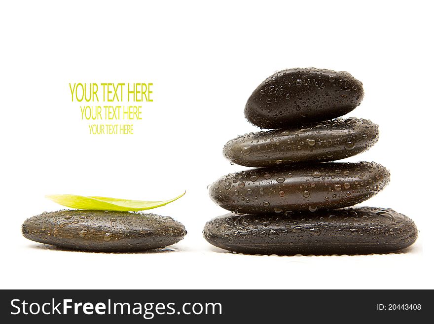 Isolated spa stones with a green leaf