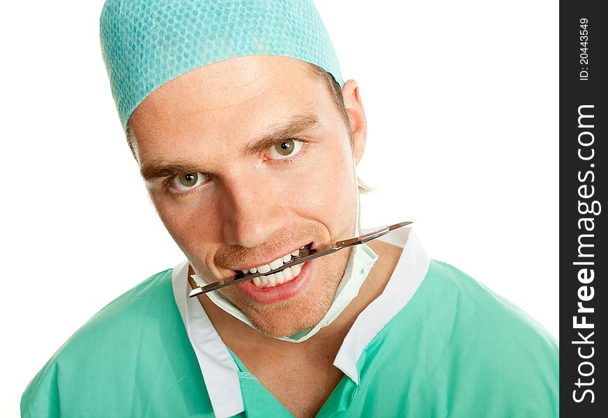 Crazy doctor with scalpel in his mouth