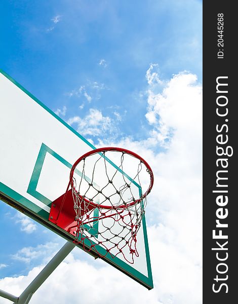 Outdoor basketball hoop on blue sky background