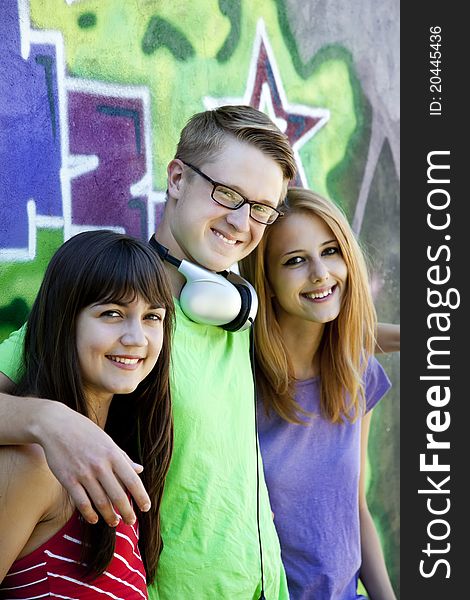 Teens With Headphones Near Graffiti Wall.