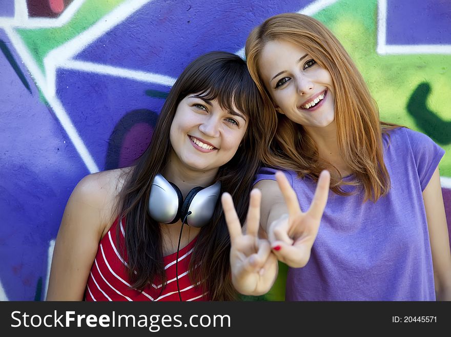 Two Girlfriends Near Graffiti Wall.