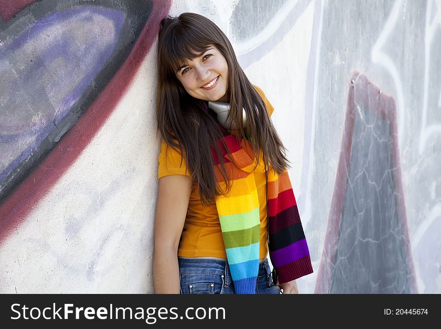 Teen Girl With Earphones Near Graffiti Wall.