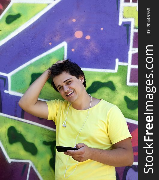 Teen near graffiti wall. Outdoor