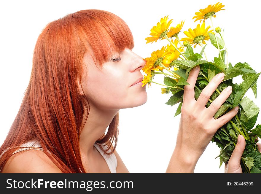 Attractive woman smelling yellow flowers. Attractive woman smelling yellow flowers