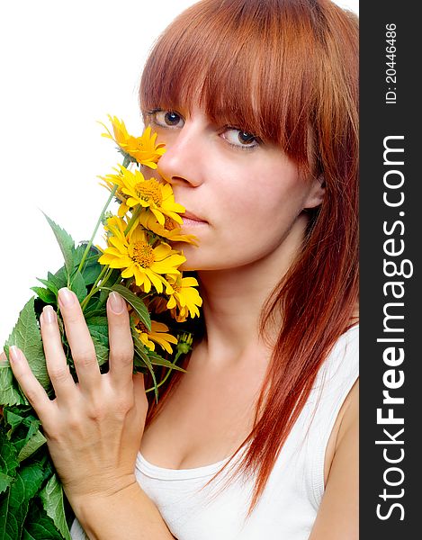 Attractive woman smelling yellow flowers. Attractive woman smelling yellow flowers