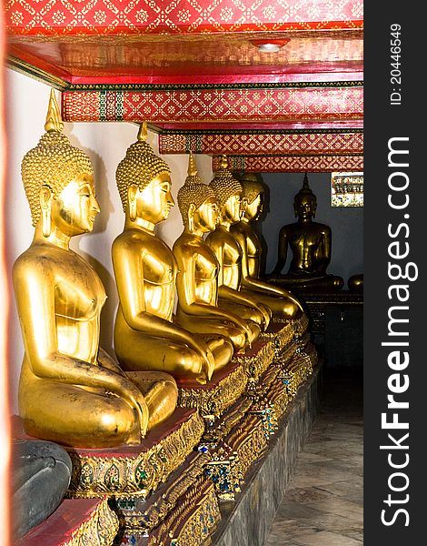 Aligned gold buddha at the royal temple thailand.