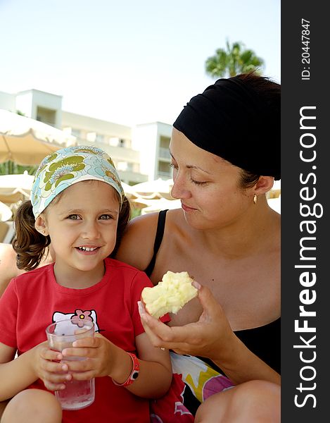 Healthy family. Mother and child eating apple and drinking water. Healthy family. Mother and child eating apple and drinking water