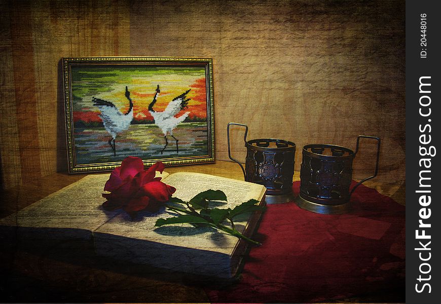 Vintage postcard with grunge background, picture, cranes, book, rose and glass-holder