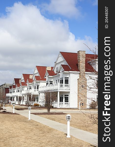 A row of white suburban townhomes. A row of white suburban townhomes