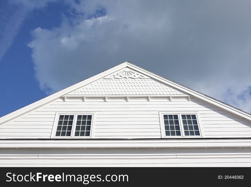 Facade view of a house in America against a cloudy sky. Facade view of a house in America against a cloudy sky