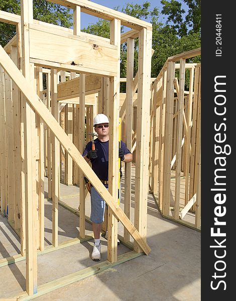 Carpenter inspecting walls for plumb, walls need to be very straight for door casing and windows