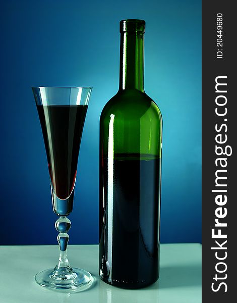 Wine bottle and glass on a blue background