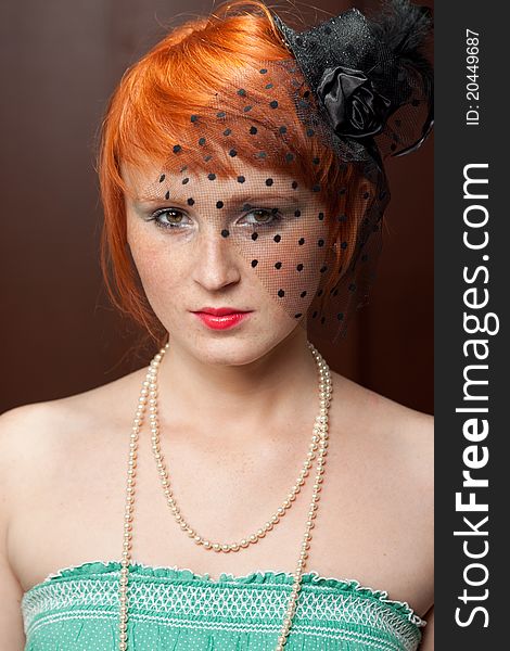 Widow redhead with freckles on brown background with red lips and beautiful eyes, with black veil. Widow redhead with freckles on brown background with red lips and beautiful eyes, with black veil