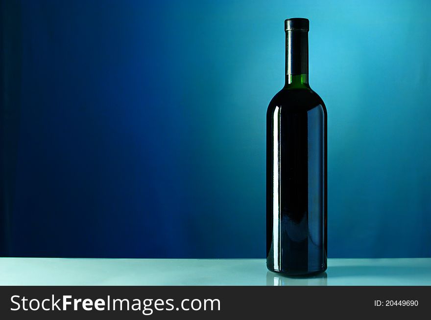 One bottle of wine on a blue background