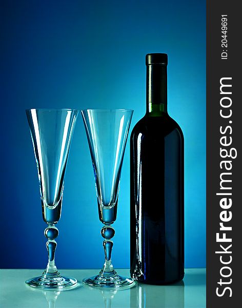 Wine Bottle And Glass On A Blue Background