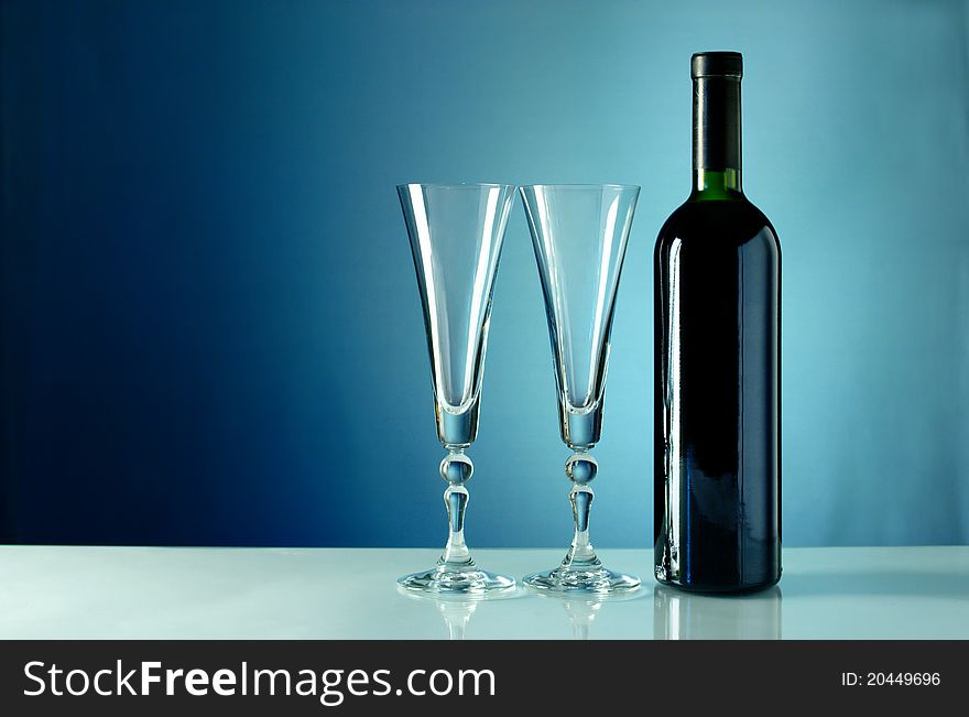 Bottle of wine and two empty glasses. Bottle of wine and two empty glasses