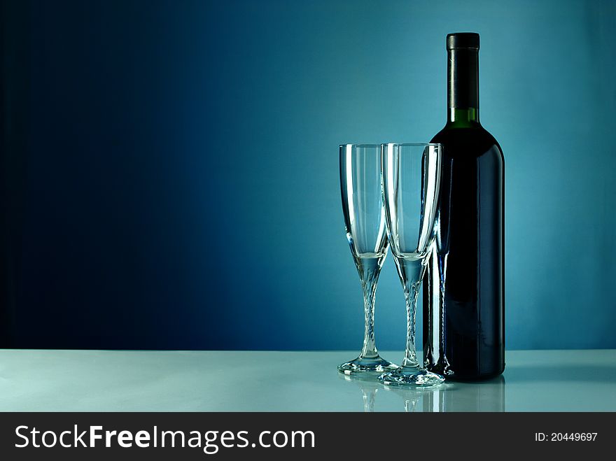 Bottle of wine and two empty glasses. Bottle of wine and two empty glasses